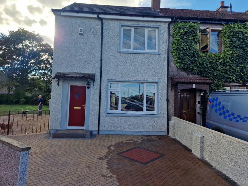 House front in new pale render with grey sills and reveals