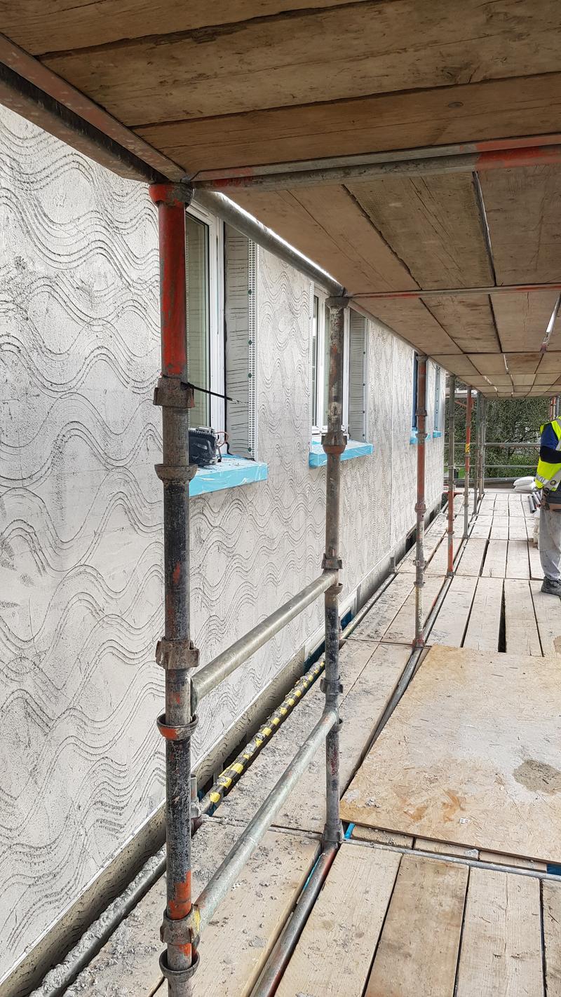 Reinforced basecoat combed out over mineral wool boards