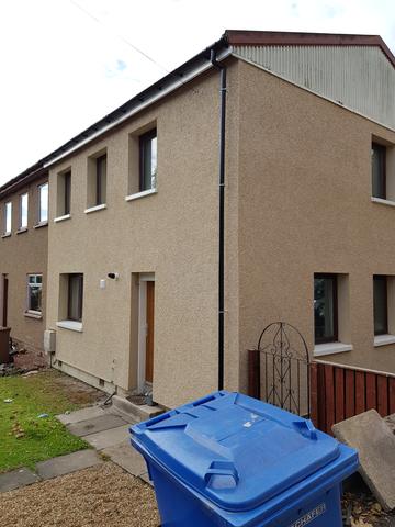 Beige roughcast across a terrace, front and gable