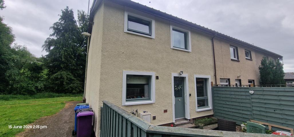 Cream render on an end-terrace with grey window surrounds