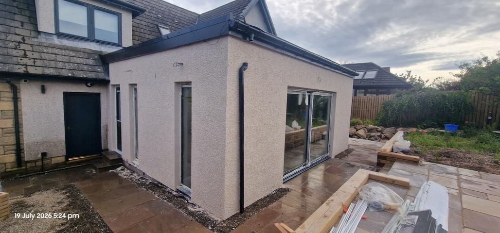 Pale render on a new single-storey extension