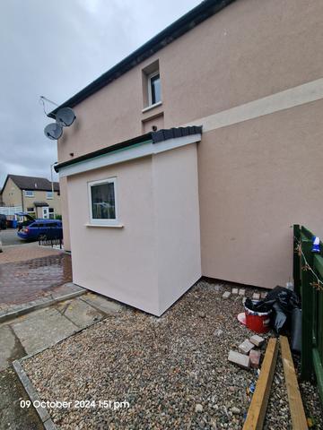 Smooth render in soft pink on a gable and return