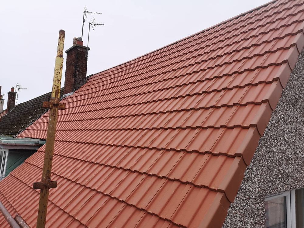 The same roof re-tiled, with new ridge, verge and roofline