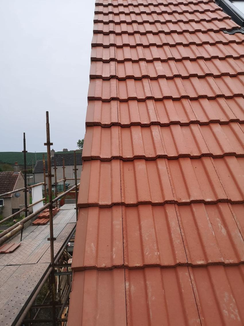 Completed roof with new ridge and verge, scaffold still in place