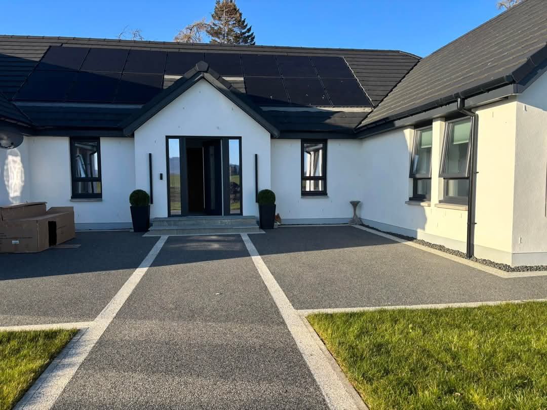 Completed bungalow with white render and a full solar array